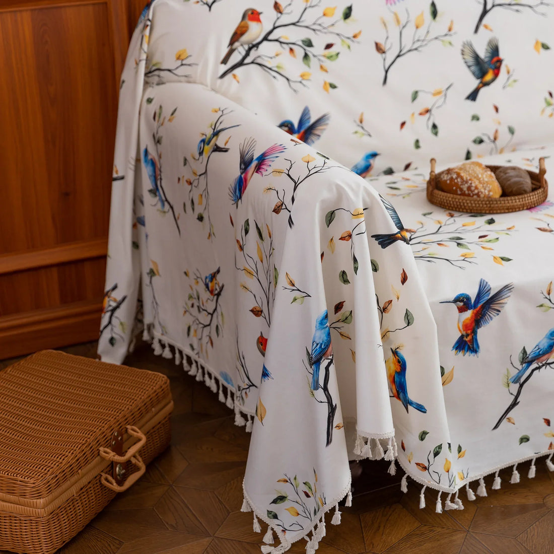 Bird Print Sofa Cover – Brighten your living space with this elegant white sofa cover adorned with colorful bird and tree branch patterns, bringing a fresh, nature-inspired touch to your décor. Crafted from soft, durable fabric with charming tassel fringe edges, it protects your couch from dust, spills, and daily wear while adding a vibrant, artistic flair. Perfect for living rooms, sunrooms, or cottages, this slipcover combines functionality with style, creating a cozy and inviting atmosphere for any seaso