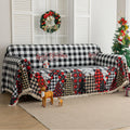 Christmas Plaid Sofa Cover – Bring holiday cheer to your home with this cozy black-and-white buffalo check sofa cover, featuring festive “Merry Christmas” lettering and colorful patchwork Christmas tree patterns in red, black, and beige tartan designs. Made from soft, durable fabric with decorative fringe edges, it protects your couch from spills, dust, and wear while adding a warm, seasonal touch. Perfect for winter décor, Christmas parties, and farmhouse-style interiors, this slipcover combines function a