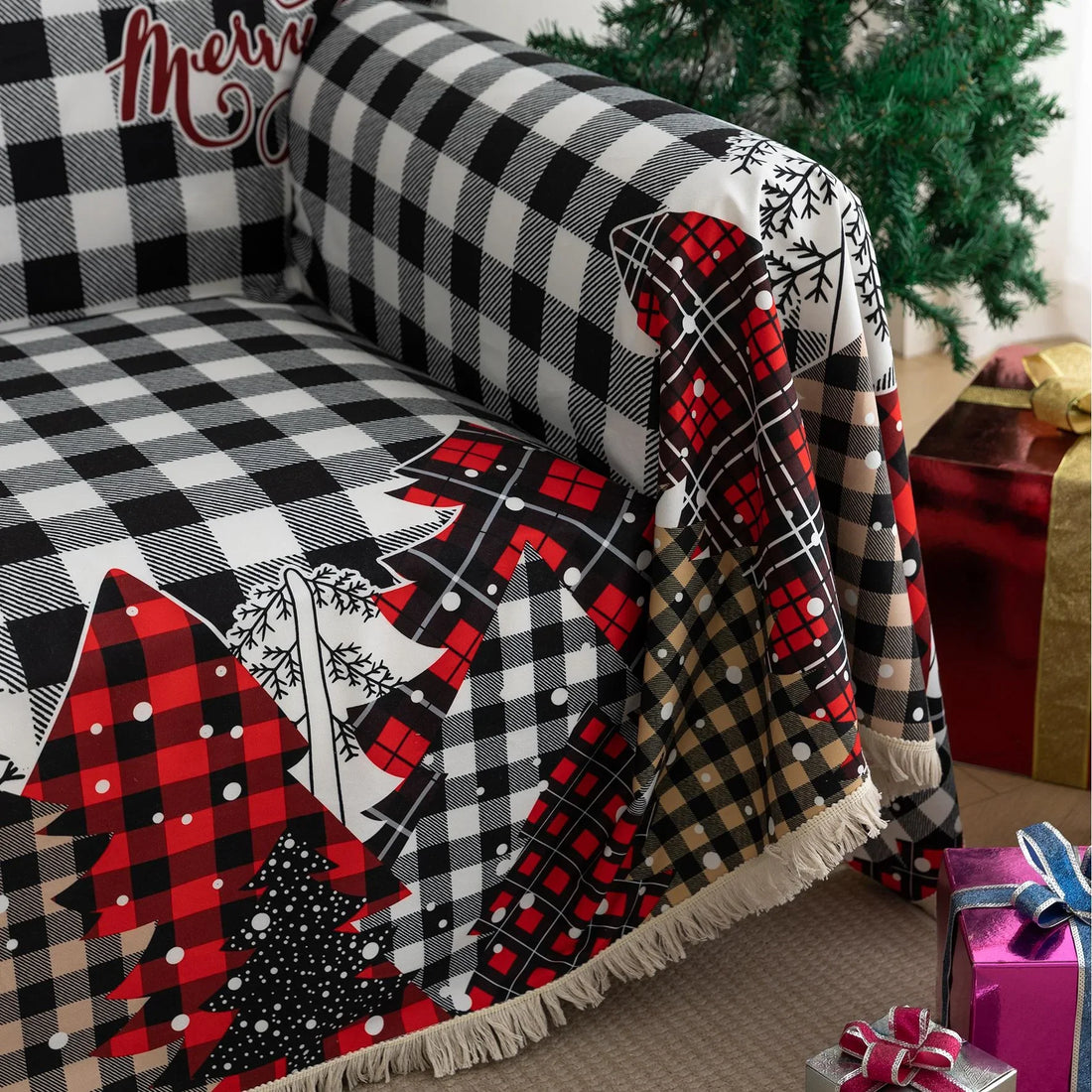 Christmas Plaid Sofa Cover – Bring holiday cheer to your home with this cozy black-and-white buffalo check sofa cover, featuring festive “Merry Christmas” lettering and colorful patchwork Christmas tree patterns in red, black, and beige tartan designs. Made from soft, durable fabric with decorative fringe edges, it protects your couch from spills, dust, and wear while adding a warm, seasonal touch. Perfect for winter décor, Christmas parties, and farmhouse-style interiors, this slipcover combines function a