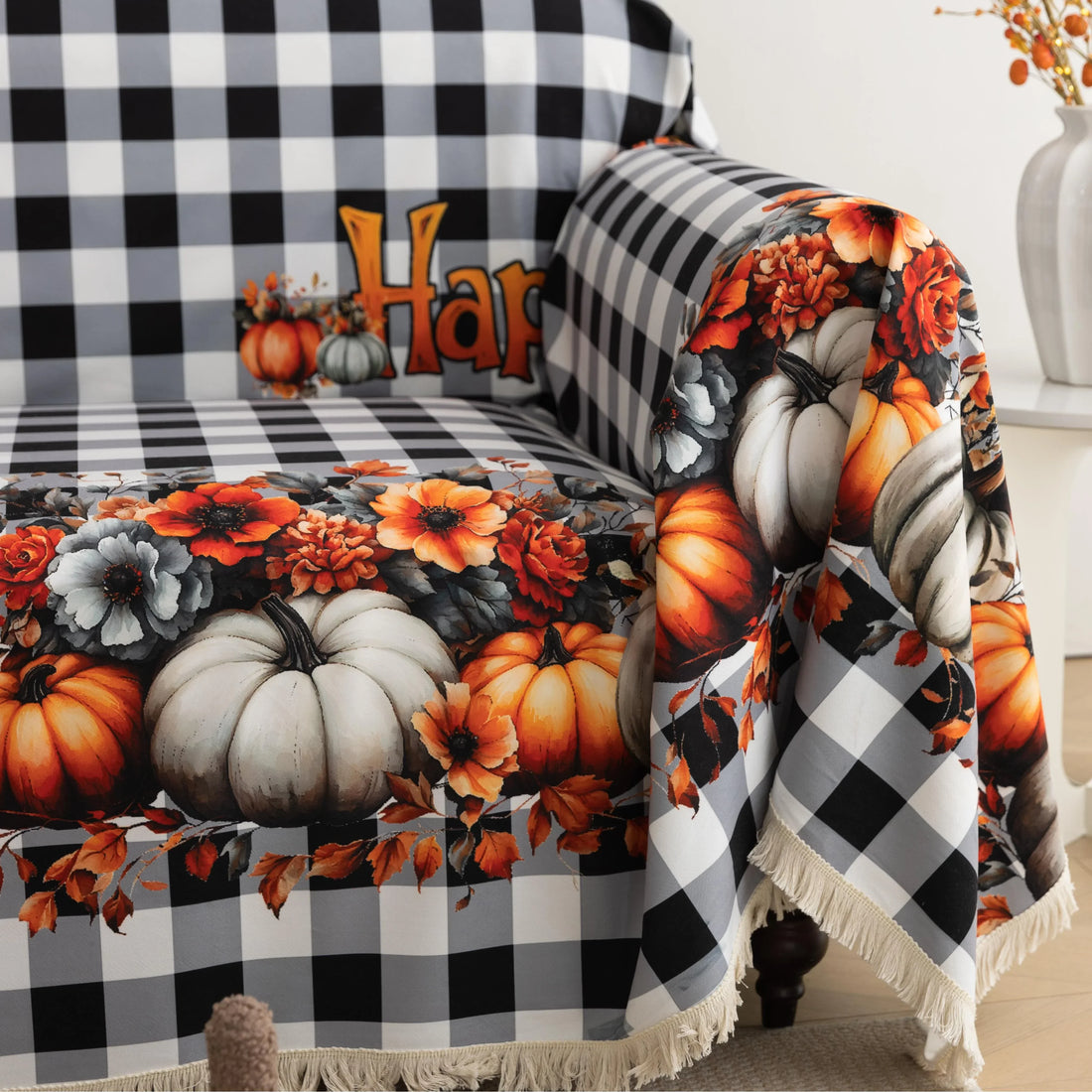 Halloween Pumpkin Plaid Sofa Cover – Give your living room a festive autumn makeover with this black-and-white buffalo check sofa cover, adorned with vibrant pumpkins, sunflowers, and “Happy Halloween” lettering. Crafted from soft, durable fabric with decorative fringe, it protects your couch from dust, spills, and wear while adding a cozy seasonal charm. Perfect for fall décor, Halloween parties, and farmhouse-style interiors, this easy-to-clean slipcover brings warmth and holiday spirit to any space.
