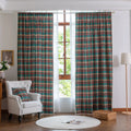Green, red, and beige plaid curtain fabric with a soft, woven texture, finished with decorative white tassel trim along the edge.