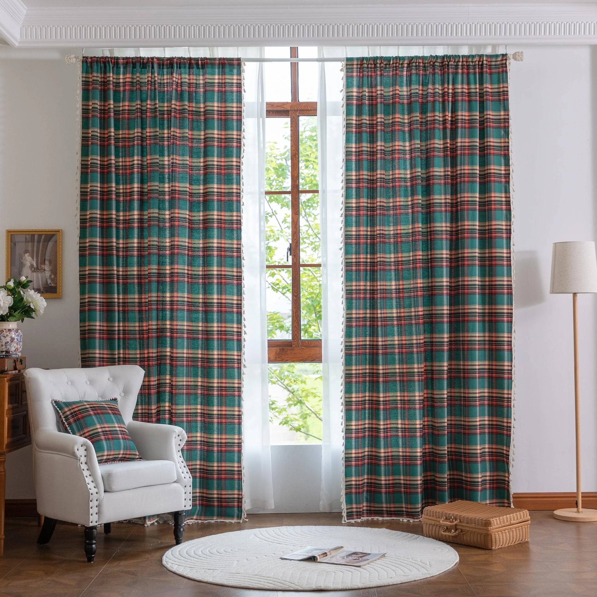 Green, red, and beige plaid curtain fabric with a soft, woven texture, finished with decorative white tassel trim along the edge.