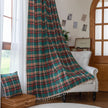 Green, red, and beige plaid curtain fabric with a soft, woven texture, finished with decorative white tassel trim along the edge.