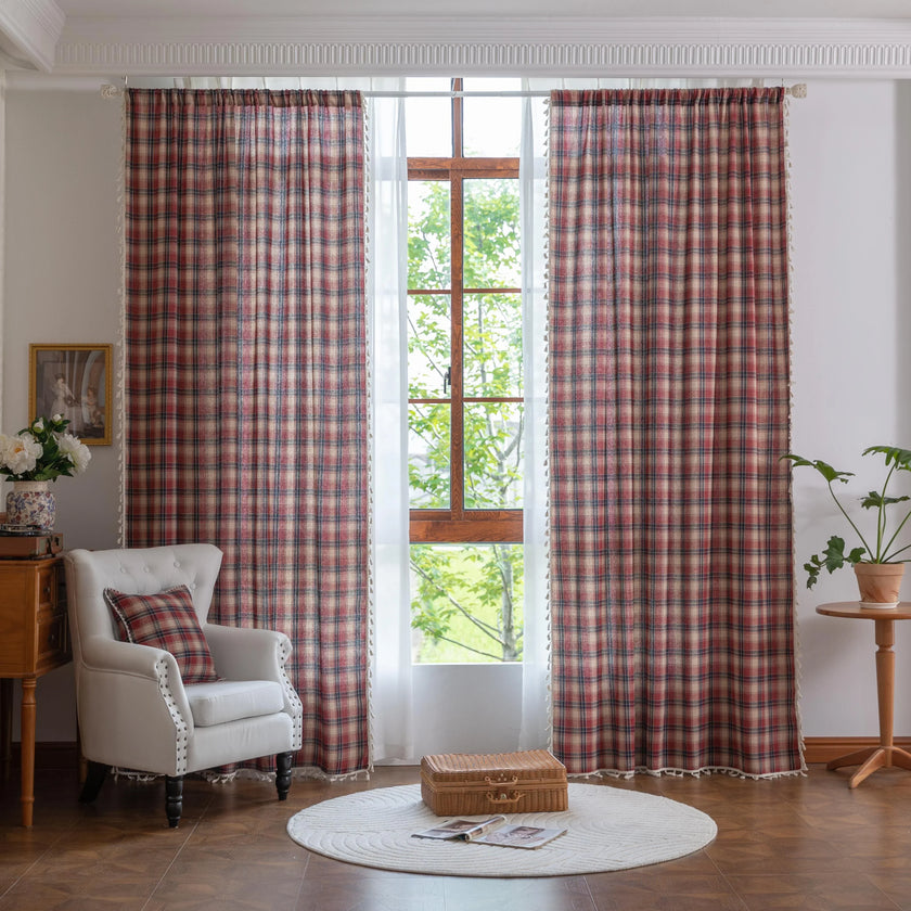 Red, navy blue, and beige plaid curtain fabric with a soft, textured weave and decorative white tassel trim on the edge.