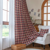 Red, navy blue, and beige plaid curtain fabric with a soft, textured weave and decorative white tassel trim on the edge.