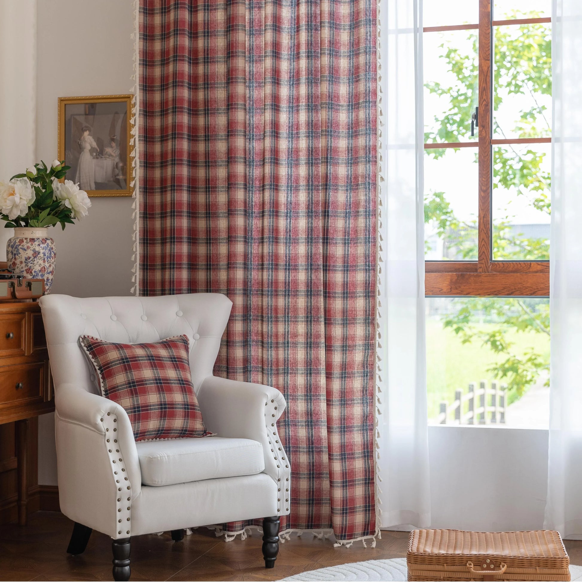 Red, navy blue, and beige plaid curtain fabric with a soft, textured weave and decorative white tassel trim on the edge.