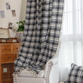 Black, gray, and beige plaid curtain fabric with a soft, woven texture and classic checkered pattern.