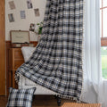 Black, gray, and beige plaid curtain fabric with a soft, woven texture and classic checkered pattern.