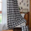 Black, gray, and beige plaid curtain fabric with a soft, woven texture and classic checkered pattern.