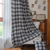 Black, gray, and beige plaid curtain fabric with a soft, woven texture and classic checkered pattern.