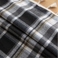 Black, gray, and beige plaid curtain fabric with a soft, woven texture and classic checkered pattern.