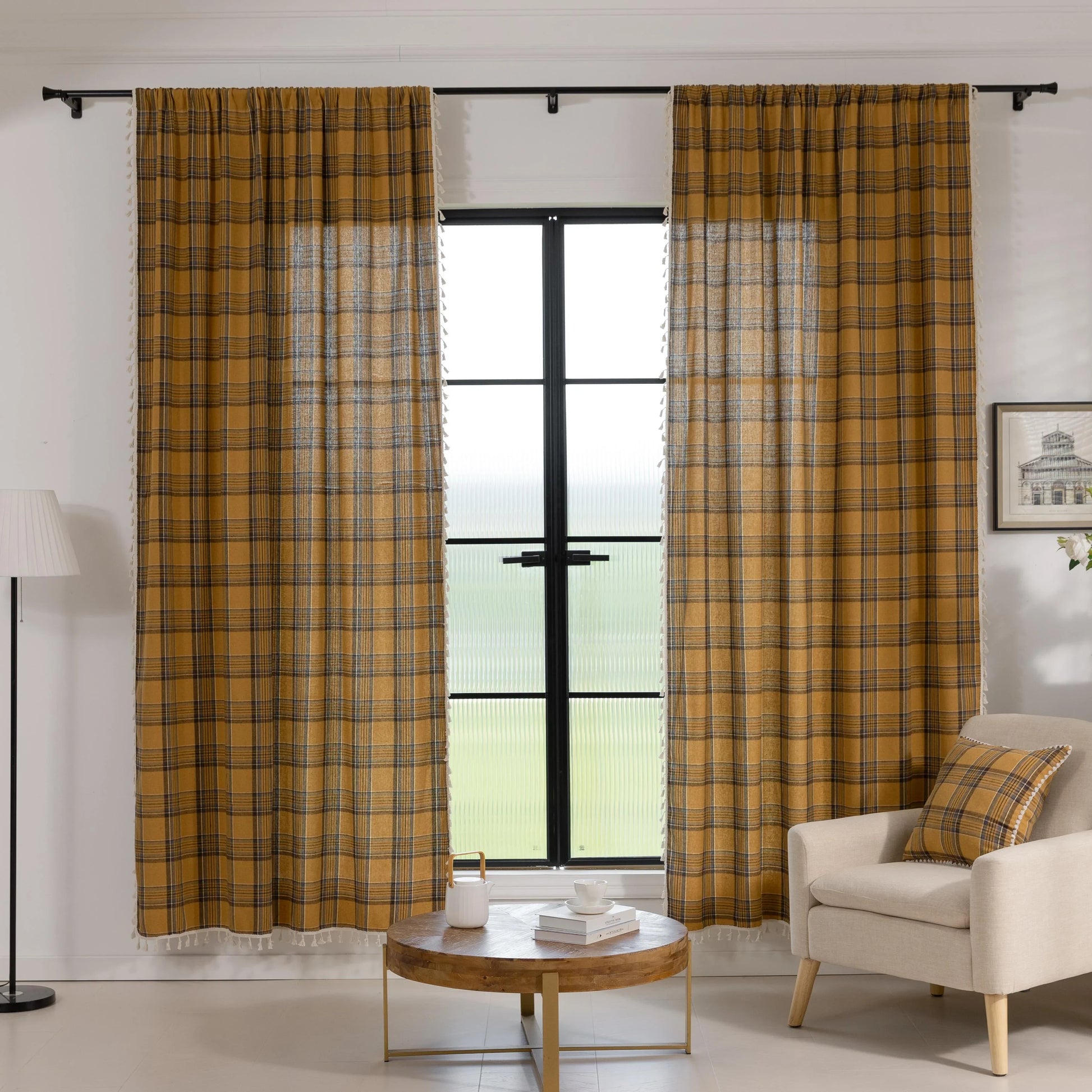 Mustard yellow and navy blue plaid curtain fabric with a soft, woven texture and decorative white tassel trim on the edge.