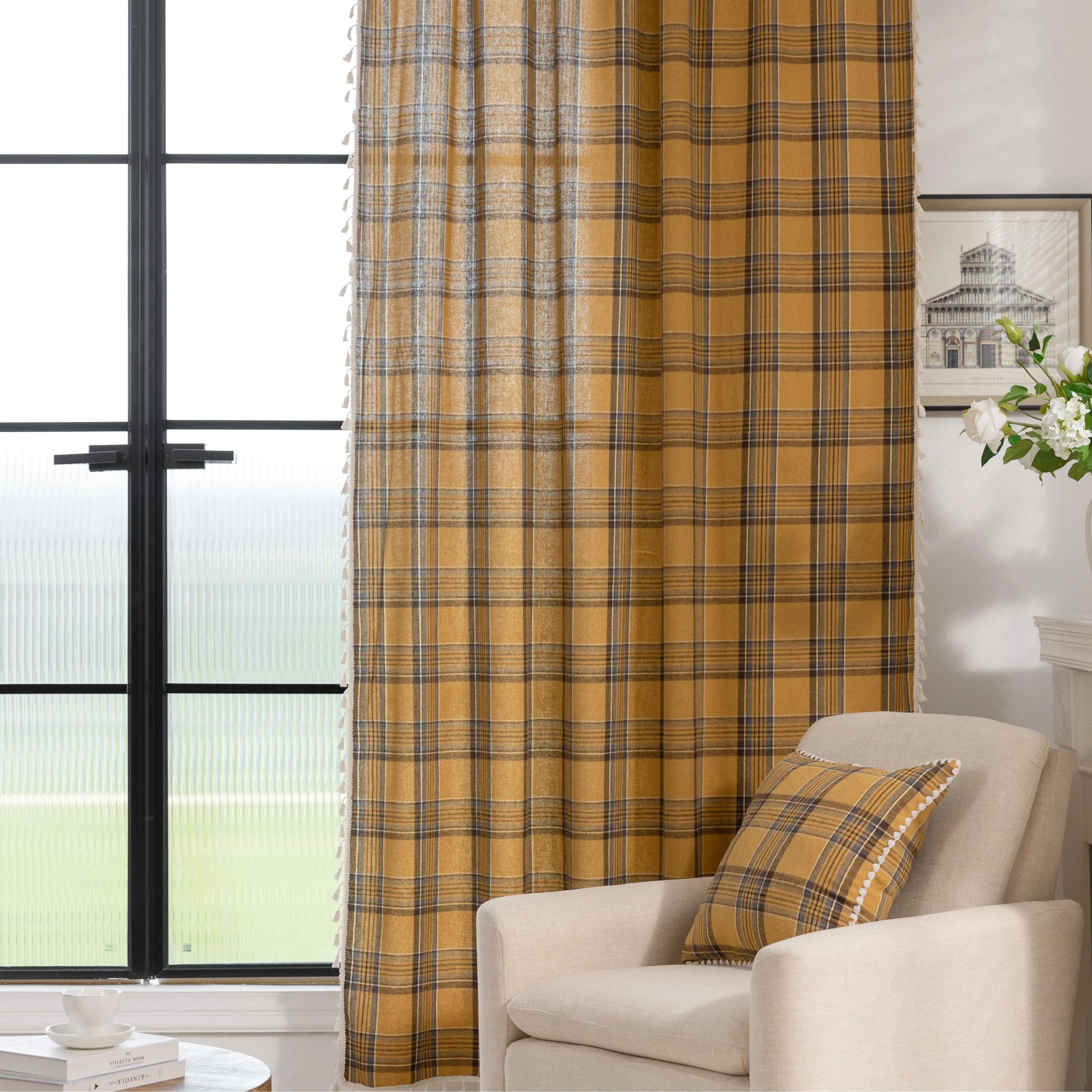 Mustard yellow and navy blue plaid curtain fabric with a soft, woven texture and decorative white tassel trim on the edge.