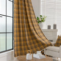 Mustard yellow and navy blue plaid curtain fabric with a soft, woven texture and decorative white tassel trim on the edge.