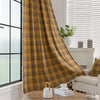 Mustard yellow and navy blue plaid curtain fabric with a soft, woven texture and decorative white tassel trim on the edge.