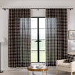 Elegant black plaid curtain fabric featuring intersecting thin white and subtle red lines, creating a classic tartan pattern.