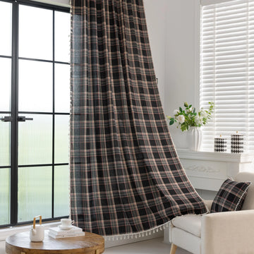 Elegant black plaid curtain fabric featuring intersecting thin white and subtle red lines, creating a classic tartan pattern.