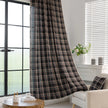 Elegant black plaid curtain fabric featuring intersecting thin white and subtle red lines, creating a classic tartan pattern.