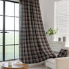 Elegant black plaid curtain fabric featuring intersecting thin white and subtle red lines, creating a classic tartan pattern.