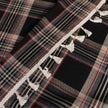 Elegant black plaid curtain fabric featuring intersecting thin white and subtle red lines, creating a classic tartan pattern.