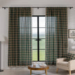 Green and beige plaid curtain fabric with a soft, woven texture, accented by decorative white tassel trim along the edge.