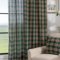 Green and beige plaid curtain fabric with a soft, woven texture, accented by decorative white tassel trim along the edge.