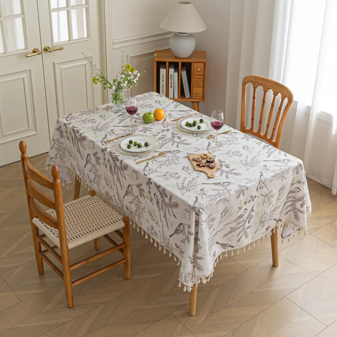 Elegant rectangular tablecloth with delicate bird and botanical prints, featuring charming tassel edges — perfect for adding a touch of nature-inspired style to dining rooms, kitchens, and special gatherings.