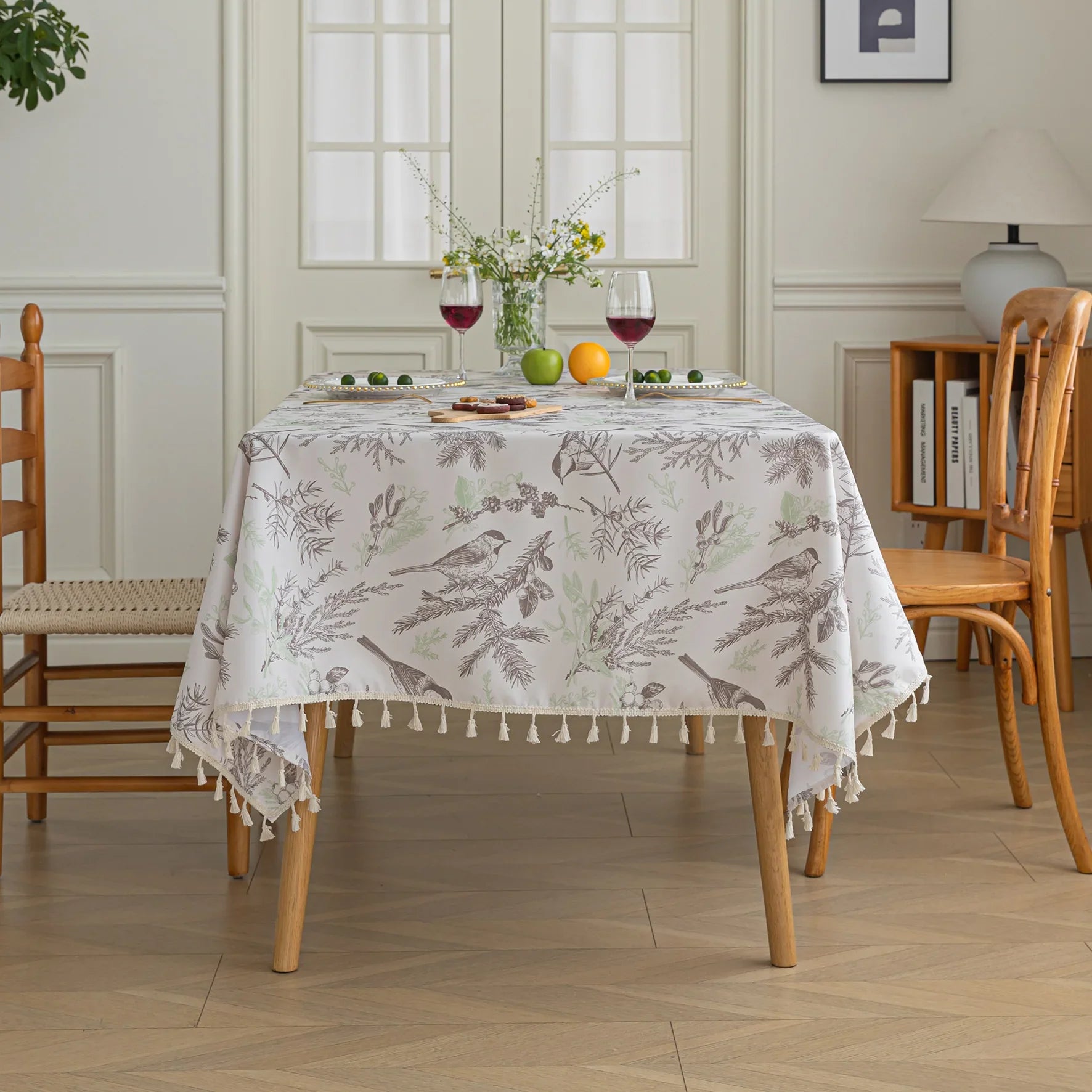 Elegant rectangular tablecloth with delicate bird and botanical prints, featuring charming tassel edges — perfect for adding a touch of nature-inspired style to dining rooms, kitchens, and special gatherings.