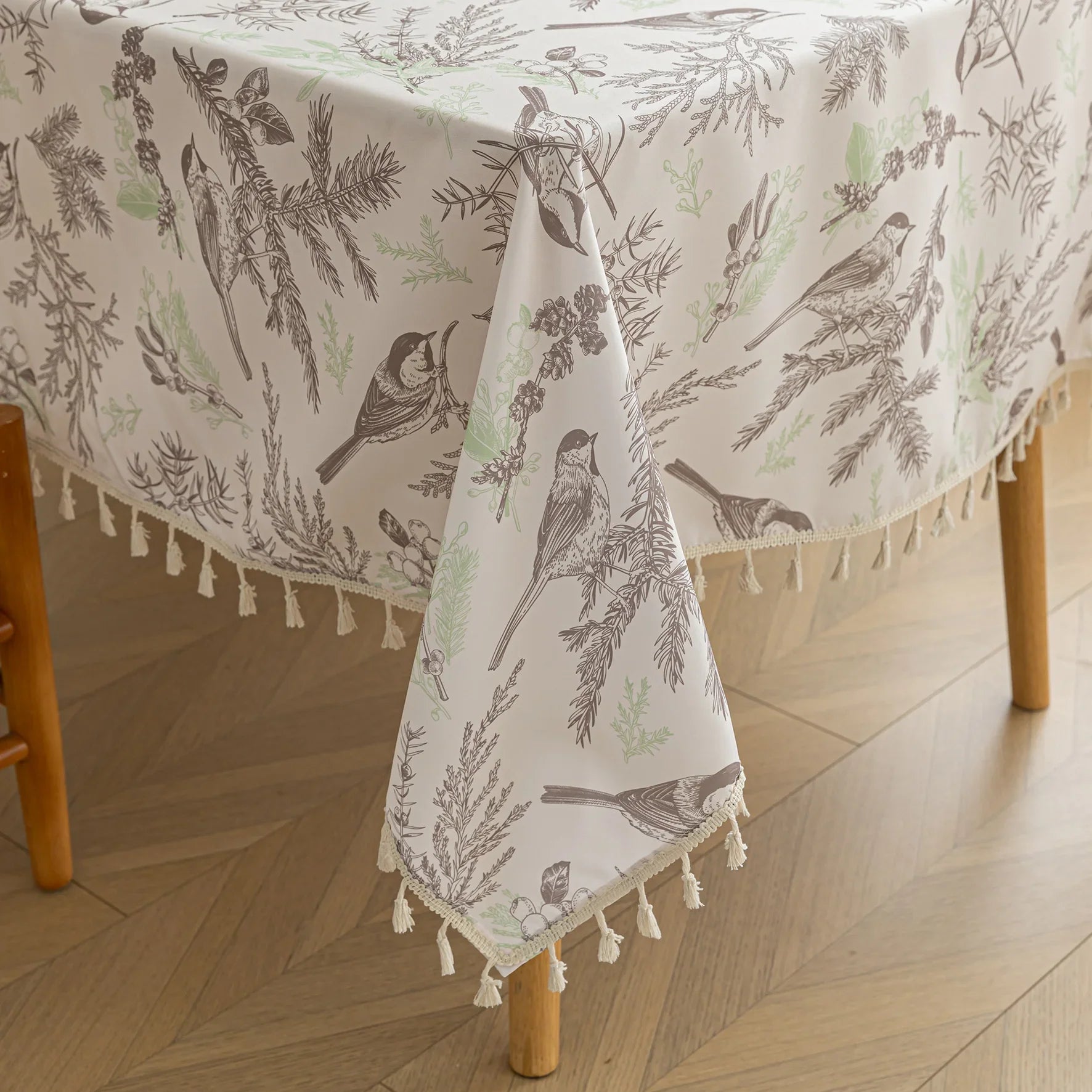 Elegant rectangular tablecloth with delicate bird and botanical prints, featuring charming tassel edges — perfect for adding a touch of nature-inspired style to dining rooms, kitchens, and special gatherings.