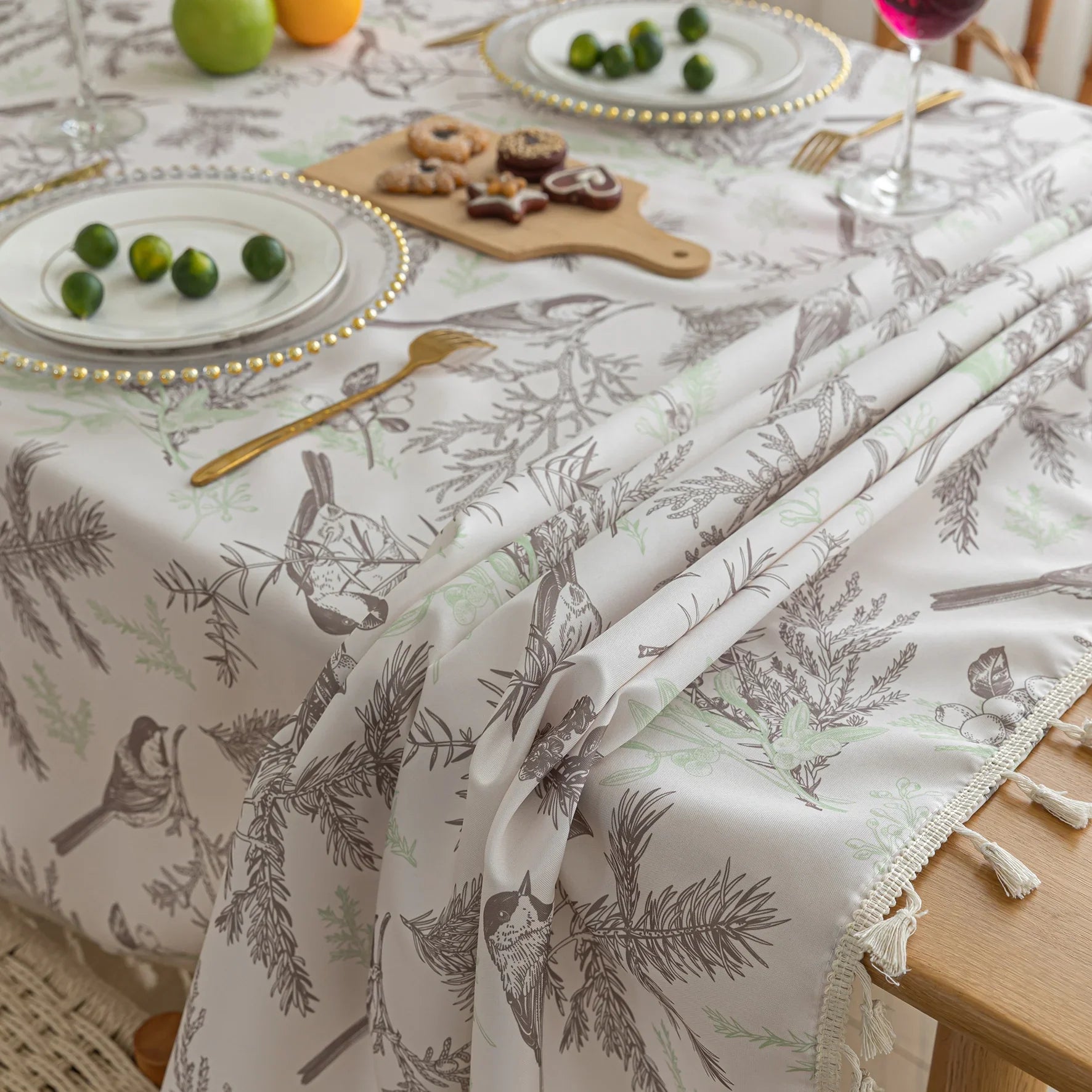 Elegant rectangular tablecloth with delicate bird and botanical prints, featuring charming tassel edges — perfect for adding a touch of nature-inspired style to dining rooms, kitchens, and special gatherings.