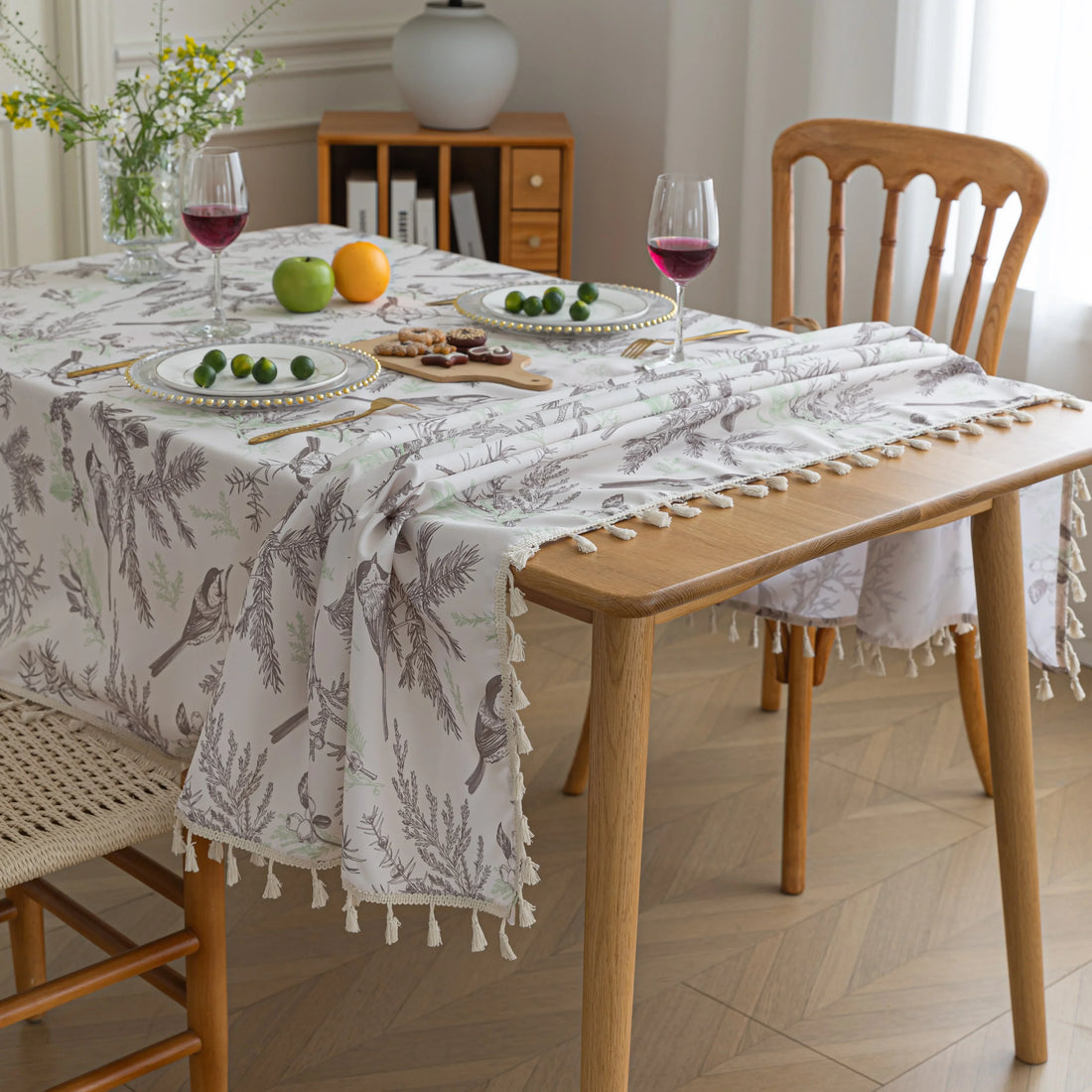 Elegant rectangular tablecloth with delicate bird and botanical prints, featuring charming tassel edges — perfect for adding a touch of nature-inspired style to dining rooms, kitchens, and special gatherings.