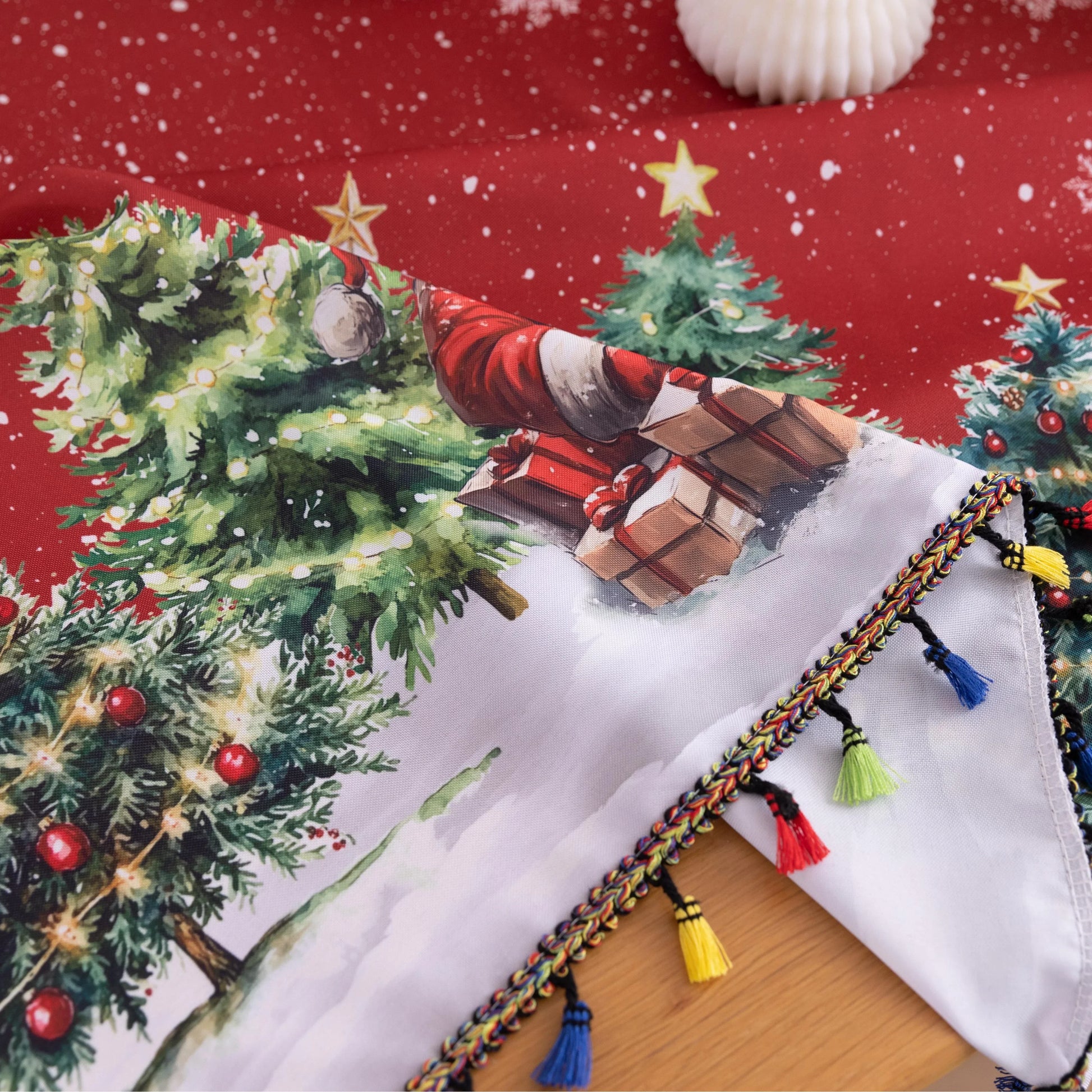 Christmas Santa Rectangular Tablecloth – Create a festive holiday atmosphere with this rectangular tablecloth featuring a snowy Christmas scene of Santa Claus, decorated pine trees, a cozy cottage, reindeer, and a cheerful snowman. Set against a rich red background with falling snowflakes and accented by playful multicolor tassels, it’s perfect for Christmas dinners, holiday parties, and seasonal home décor. Durable and eye-catching, this tablecloth brings warmth and joy to any dining space.
