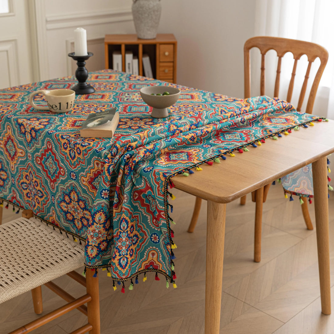 Bohemian Rectangle Tablecloth – Add vibrant charm to your dining area with this colorful round tablecloth featuring intricate Moroccan-inspired patterns in bold turquoise, red, and yellow hues. Finished with playful multicolor tassels along the edge, it brings a lively boho flair to both indoor and outdoor dining. Perfect for kitchen tables, coffee nooks, or garden parties, this durable and eye-catching tablecloth is ideal for everyday use or special occasions.
