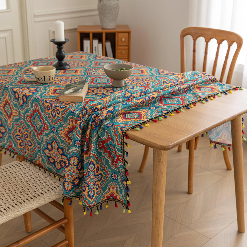 Bohemian Rectangle Tablecloth ¨C Add vibrant charm to your dining area with this colorful round tablecloth featuring intricate Moroccan-inspired patterns in bold turquoise, red, and yellow hues. Finished with playful multicolor tassels along the edge, it brings a lively boho flair to both indoor and outdoor dining. Perfect for kitchen tables, coffee nooks, or garden parties, this durable and eye-catching tablecloth is ideal for everyday use or special occasions.
