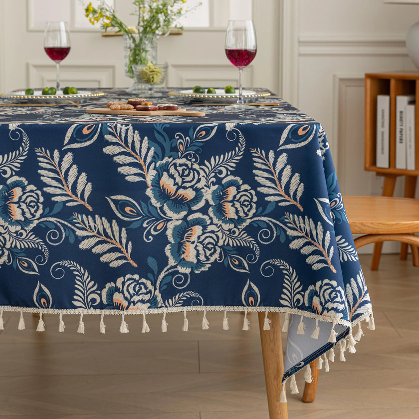 Elegant Floral RectangleTablecloth ¨C Enhance your dining space with this stylish round tablecloth featuring a deep navy blue background adorned with delicate white and beige floral patterns. Accented with charming white tassels along the edge, it brings a refined yet cozy touch to your table d¨¦cor. Perfect for everyday meals, afternoon tea, or special gatherings, this durable and decorative tablecloth suits both modern and classic interiors.
