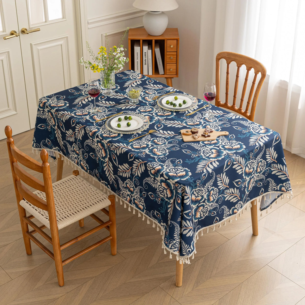 Elegant Floral RectangleTablecloth ¨C Enhance your dining space with this stylish round tablecloth featuring a deep navy blue background adorned with delicate white and beige floral patterns. Accented with charming white tassels along the edge, it brings a refined yet cozy touch to your table d¨¦cor. Perfect for everyday meals, afternoon tea, or special gatherings, this durable and decorative tablecloth suits both modern and classic interiors.
