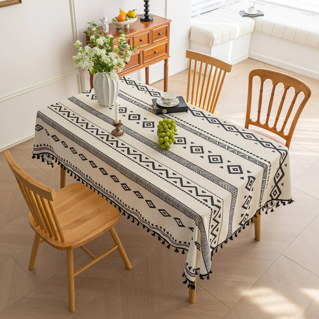 Modern black and white geometric patterned tablecloth with tribal-inspired diamond and stripe designs.