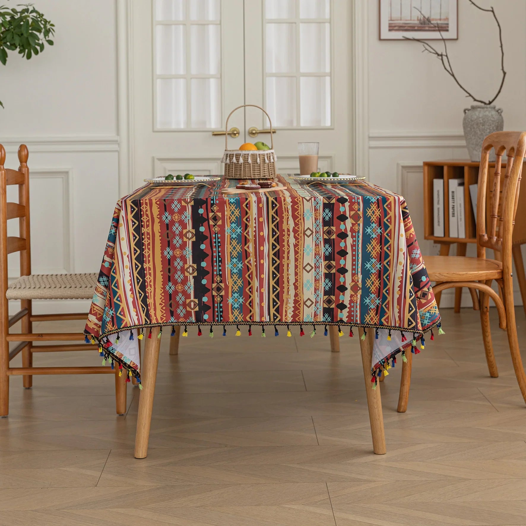 Vibrant bohemian tablecloth with colorful geometric patterns and playful tassel trim — perfect for adding warmth and personality to dining tables, picnics, and festive gatherings.