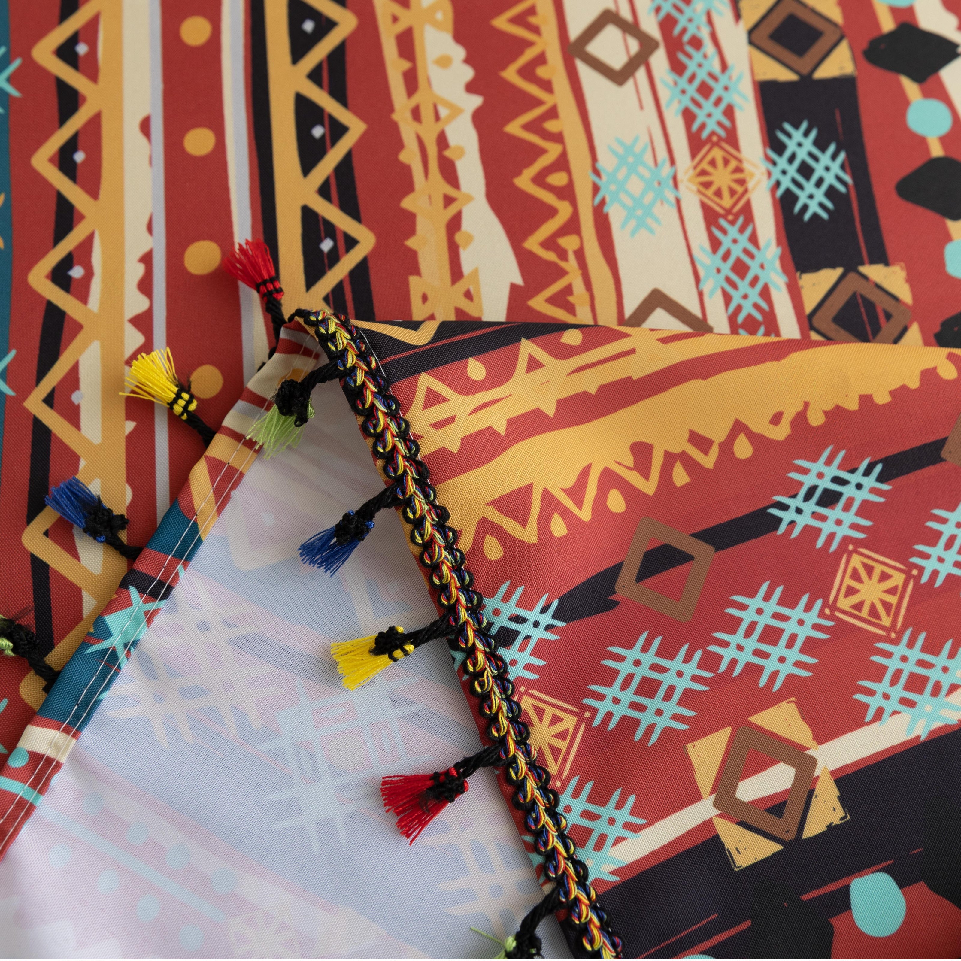Vibrant bohemian tablecloth with colorful geometric patterns and playful tassel trim ¡ª perfect for adding warmth and personality to dining tables, picnics, and festive gatherings.