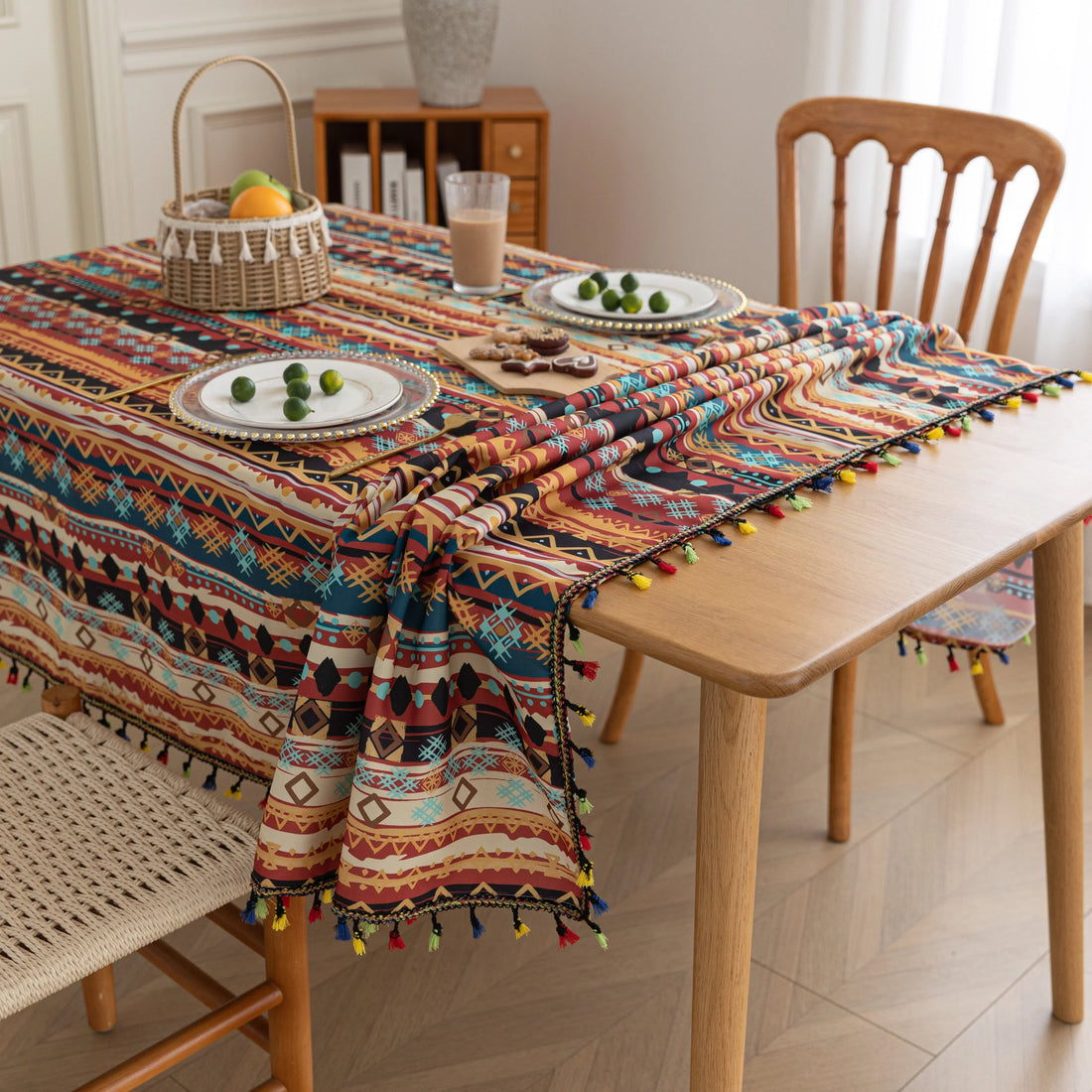 Vibrant bohemian tablecloth with colorful geometric patterns and playful tassel trim — perfect for adding warmth and personality to dining tables, picnics, and festive gatherings.