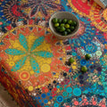 Colorful mandala tablecloth with intricate bohemian patterns and playful tassel edging — ideal for brightening up dining tables, outdoor picnics, or festive celebrations with vibrant charm.