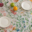 Elegant floral tablecloth with lush green leaves and soft pastel blossoms, accented by delicate tassel edging ¡ª perfect for adding a fresh, nature-inspired touch to dining rooms, garden parties, or spring gatherings.