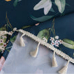 Chic dark floral tablecloth featuring vibrant botanical prints on a deep navy background, finished with elegant tassel edges ¡ª ideal for elevating dining d¨¦cor, special occasions, and stylish everyday meals.