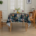 Chic dark floral tablecloth featuring vibrant botanical prints on a deep navy background, finished with elegant tassel edges — ideal for elevating dining décor, special occasions, and stylish everyday meals.