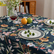 Chic dark floral tablecloth featuring vibrant botanical prints on a deep navy background, finished with elegant tassel edges ¡ª ideal for elevating dining d¨¦cor, special occasions, and stylish everyday meals.