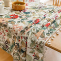 Beautiful floral tablecloth with vibrant red, green, and beige botanical patterns, enhanced by delicate tassel edging — perfect for adding a warm, inviting touch to everyday dining or festive gatherings.