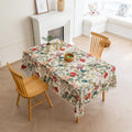 Beautiful floral tablecloth with vibrant red, green, and beige botanical patterns, enhanced by delicate tassel edging — perfect for adding a warm, inviting touch to everyday dining or festive gatherings.