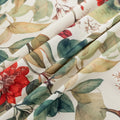 Beautiful floral tablecloth with vibrant red, green, and beige botanical patterns, enhanced by delicate tassel edging — perfect for adding a warm, inviting touch to everyday dining or festive gatherings.