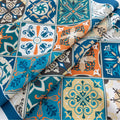 Elegant boho-style tablecloth with colorful geometric patterns and tassels, perfect for adding charm and protecting your dining table.