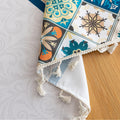 Elegant boho-style tablecloth with colorful geometric patterns and tassels, perfect for adding charm and protecting your dining table.